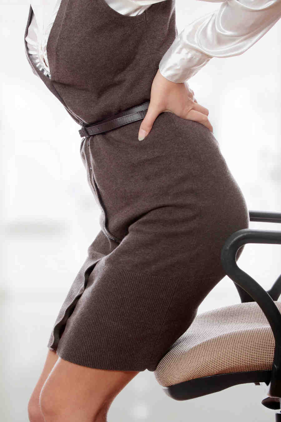 Woman-with-back-pain-needs-chiropractor-after-sitting-in-office-chair-for-too-long-2.jpg